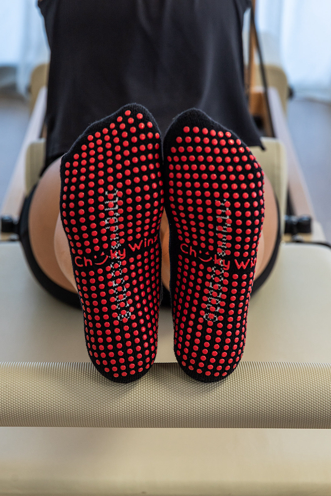 Black and red textured socks with visible brand name on a neutral background