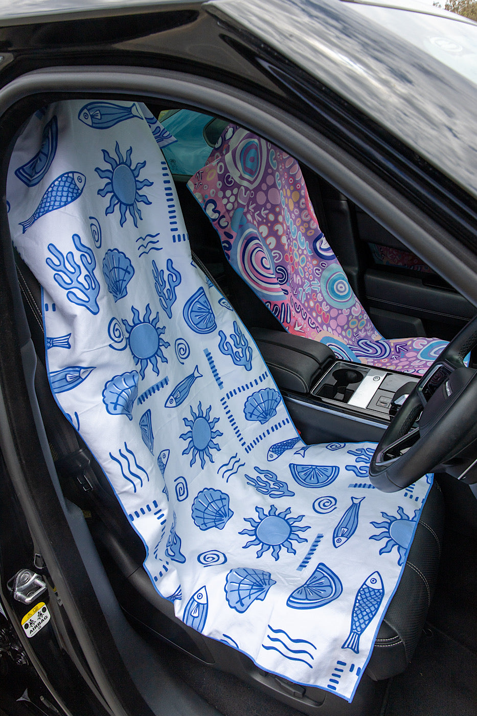 Car seat cover with blue sea-themed pattern on a vehicle seat