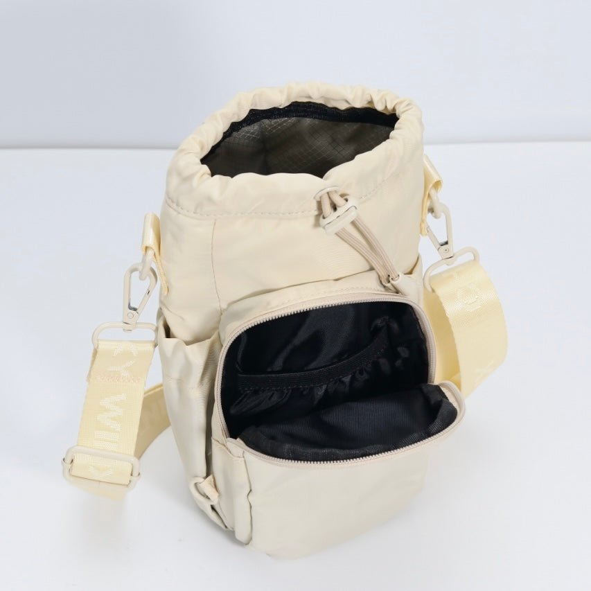 Cream water bottle bag with anti-theft zips and hidden passport pocket by Cheeky Winx