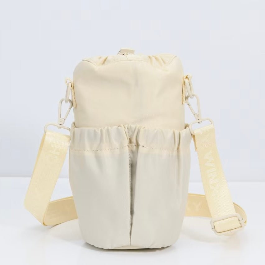 Cream water bottle bag with anti-theft zips and hidden passport pocket by Cheeky Winx